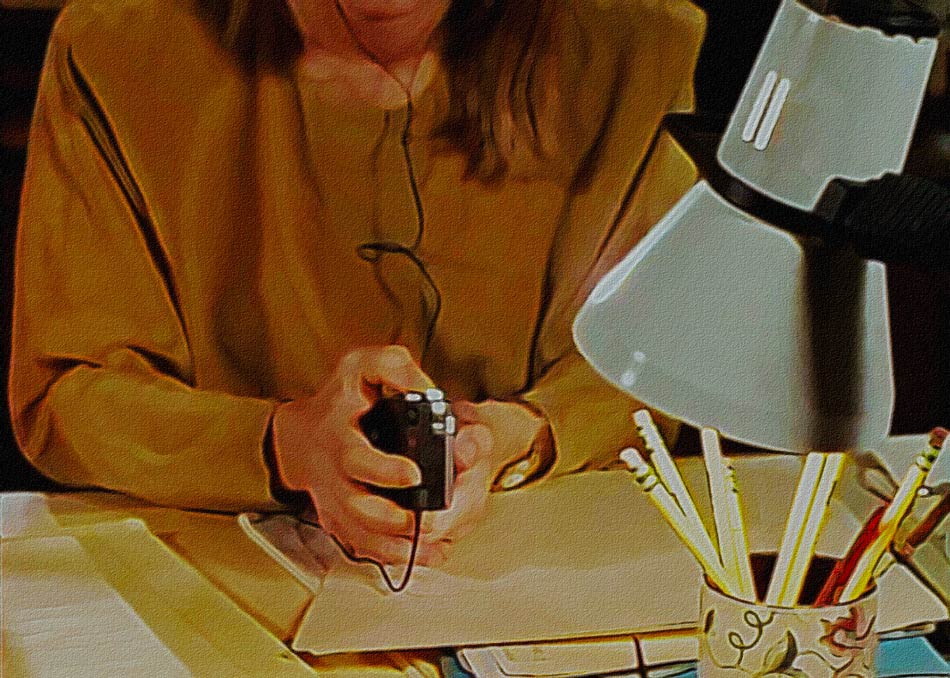 Catherine at her desk working with a voice recorder