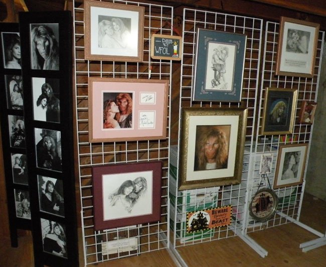 framed batb art hanging on a wire floor stand